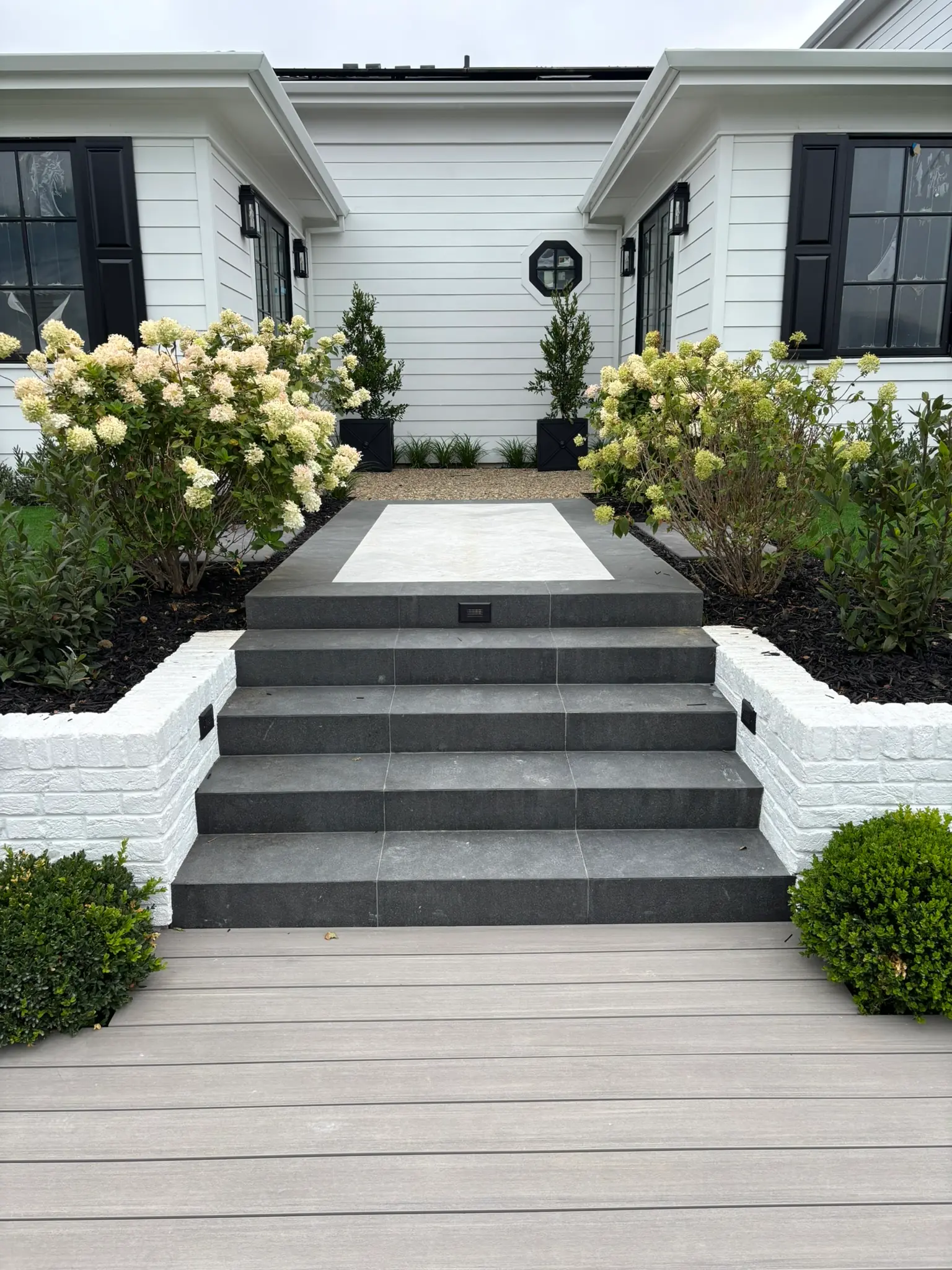 Finished outdoor landscaping project with patio and pavers