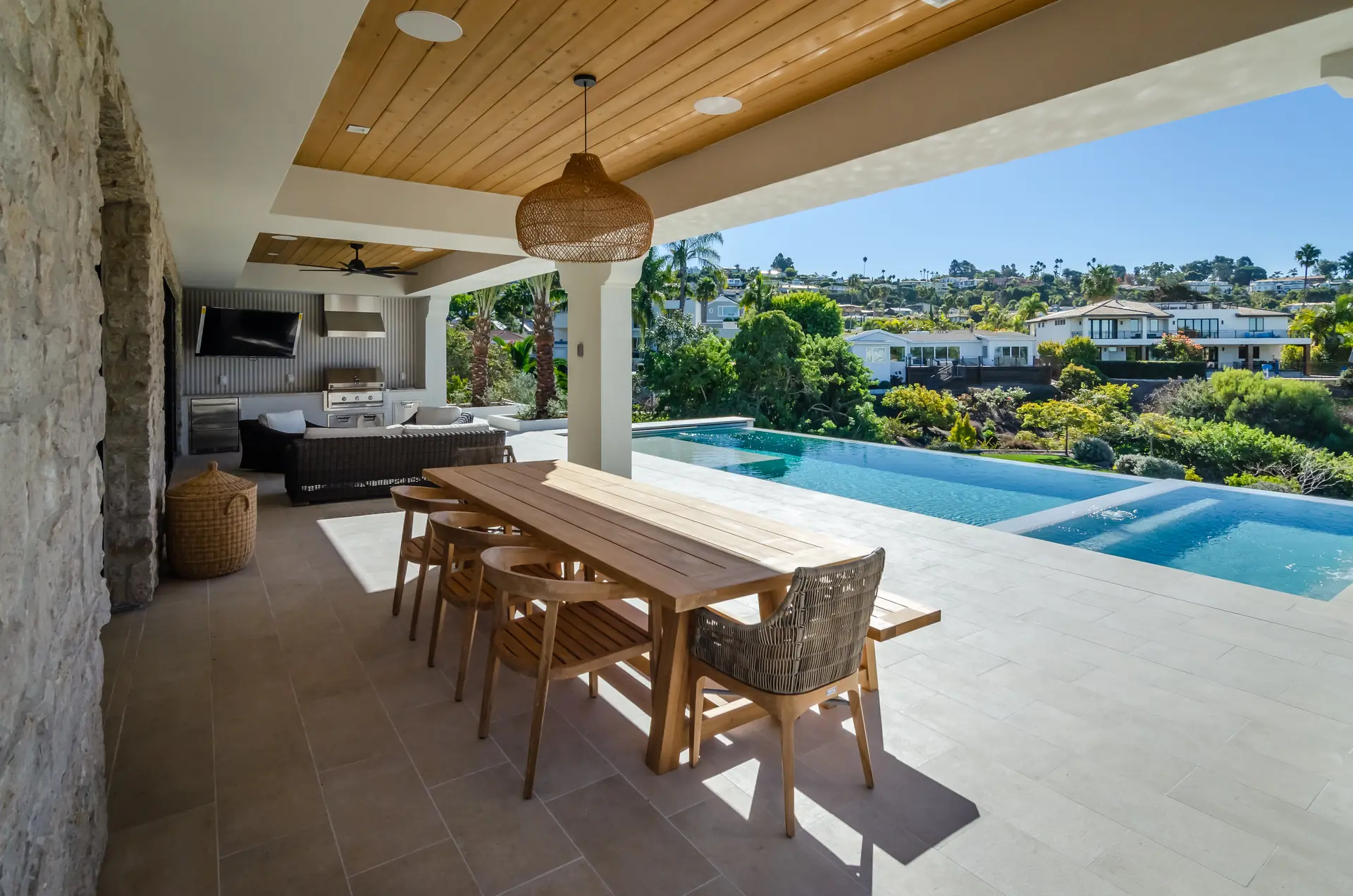 Custom outdoor kitchen and fireplace in a luxury backyard