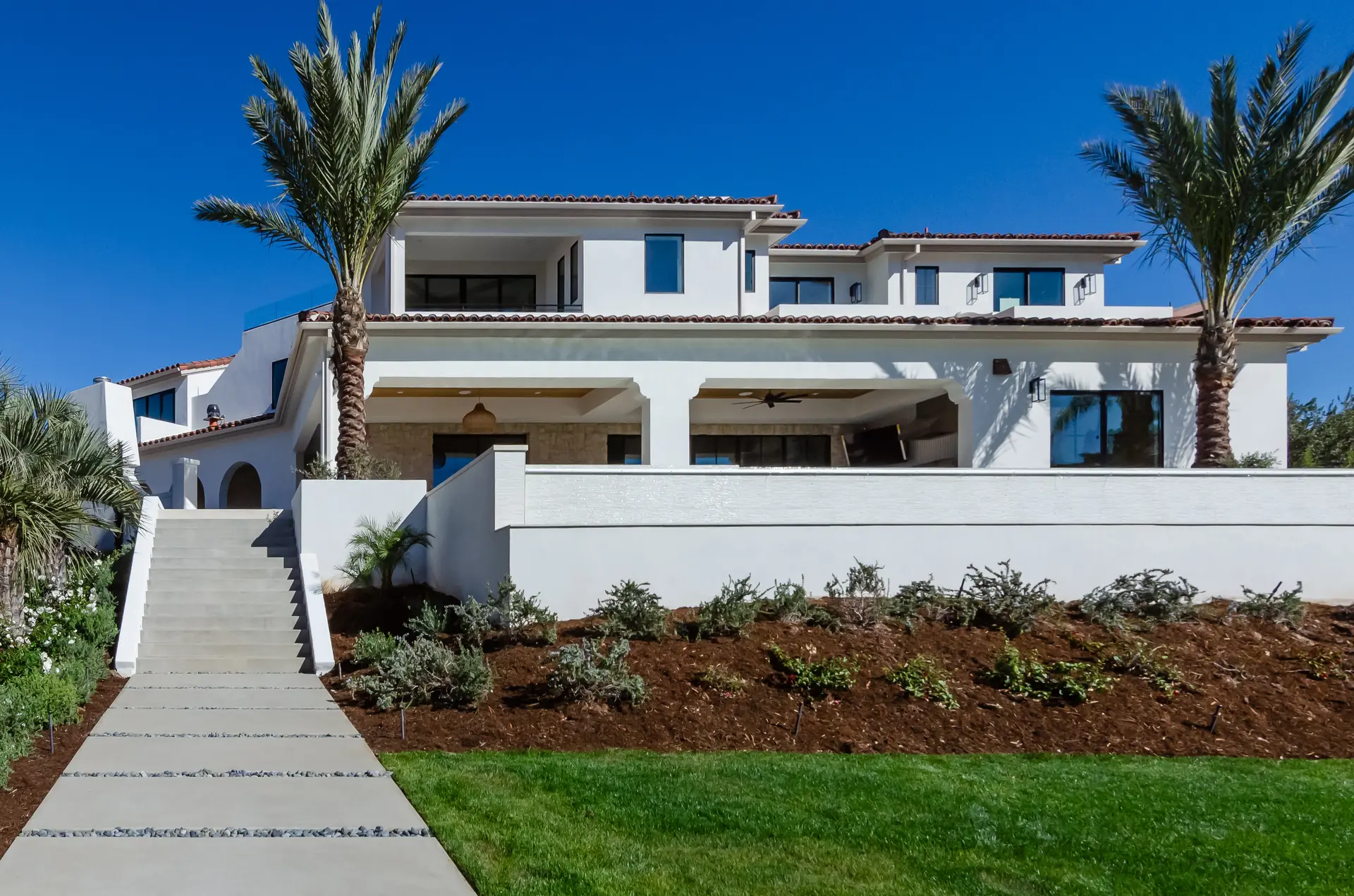 Luxury landscaped backyard with patio and outdoor living space