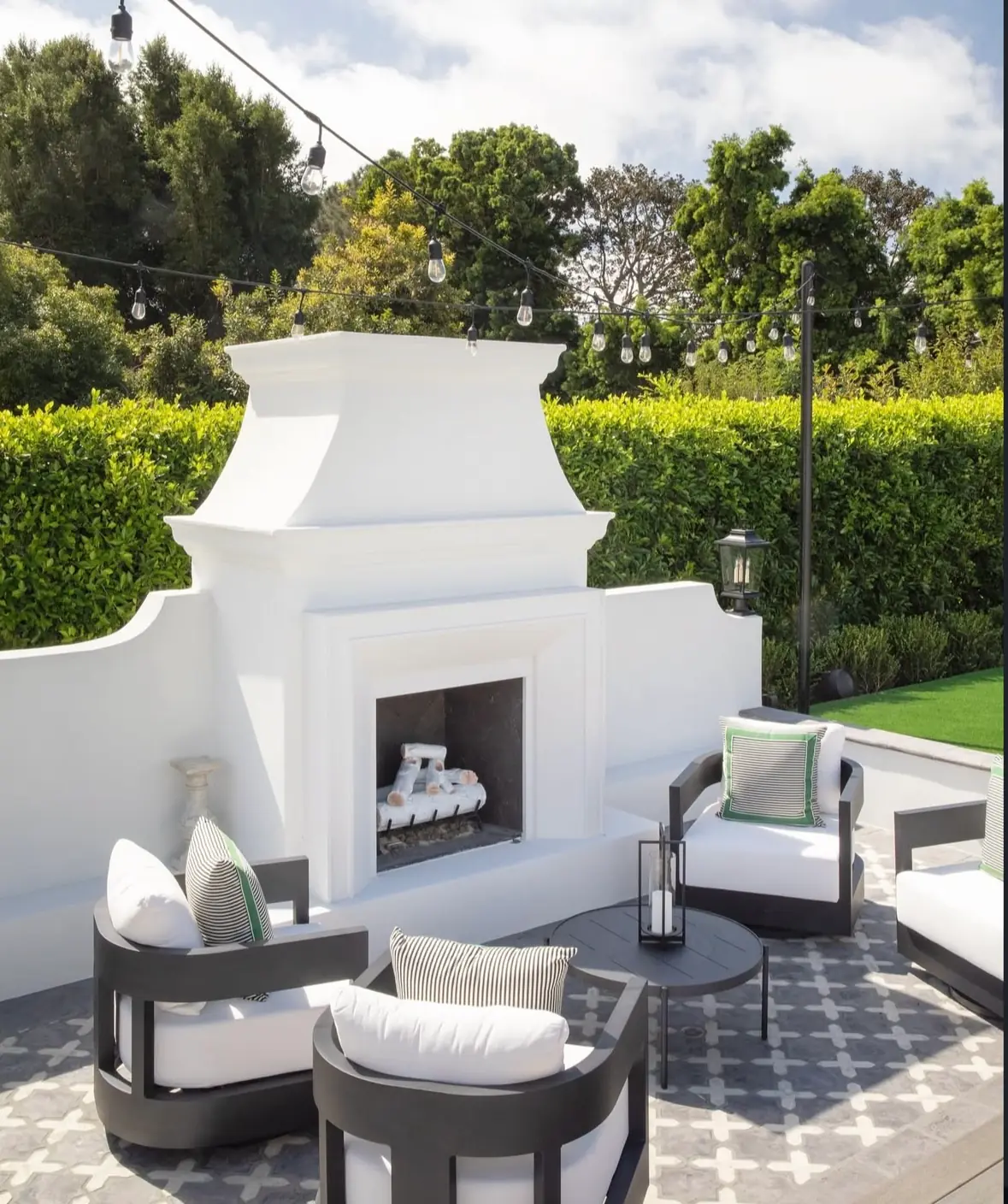 Fire pit glowing in a beautifully landscaped backyard at dusk