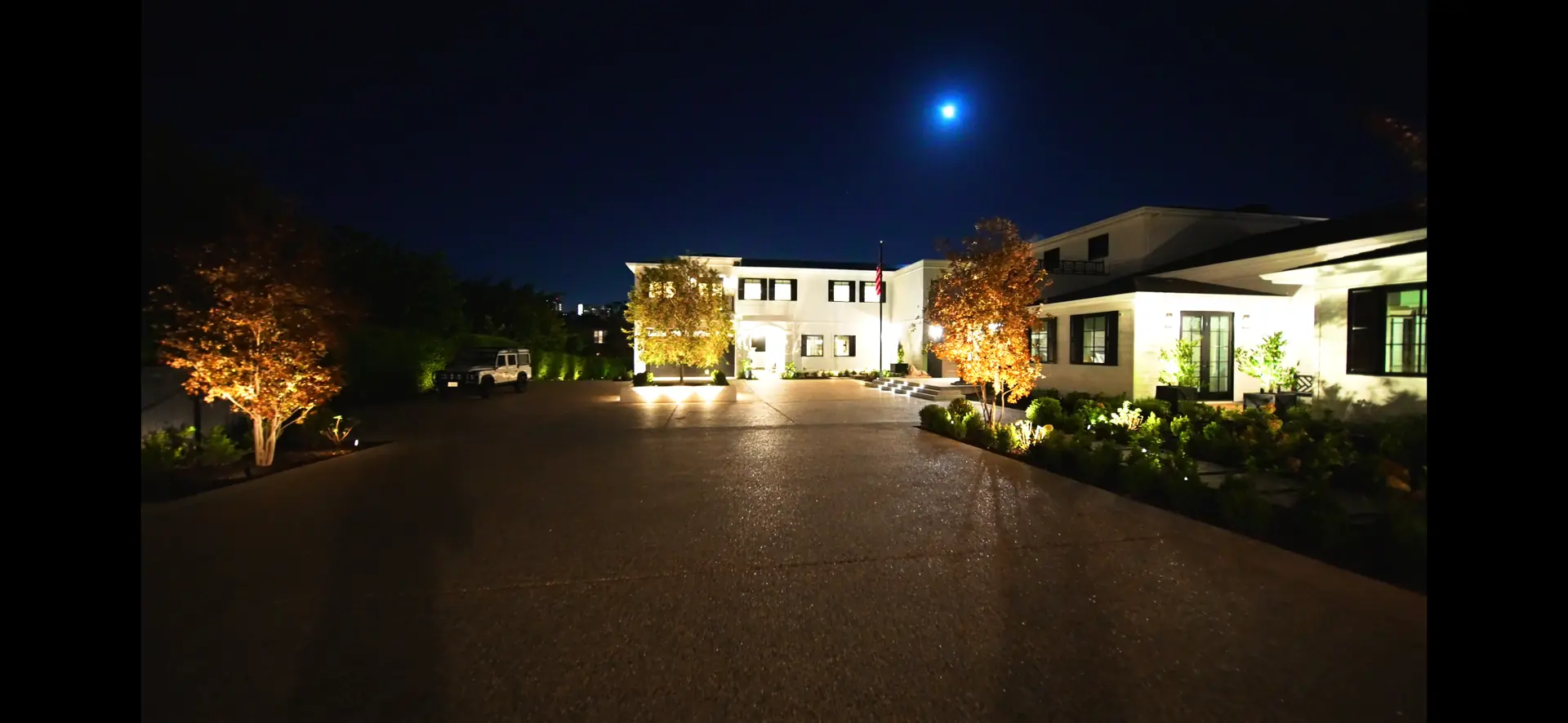 Luxury backyard at golden hour with warm ambient lighting