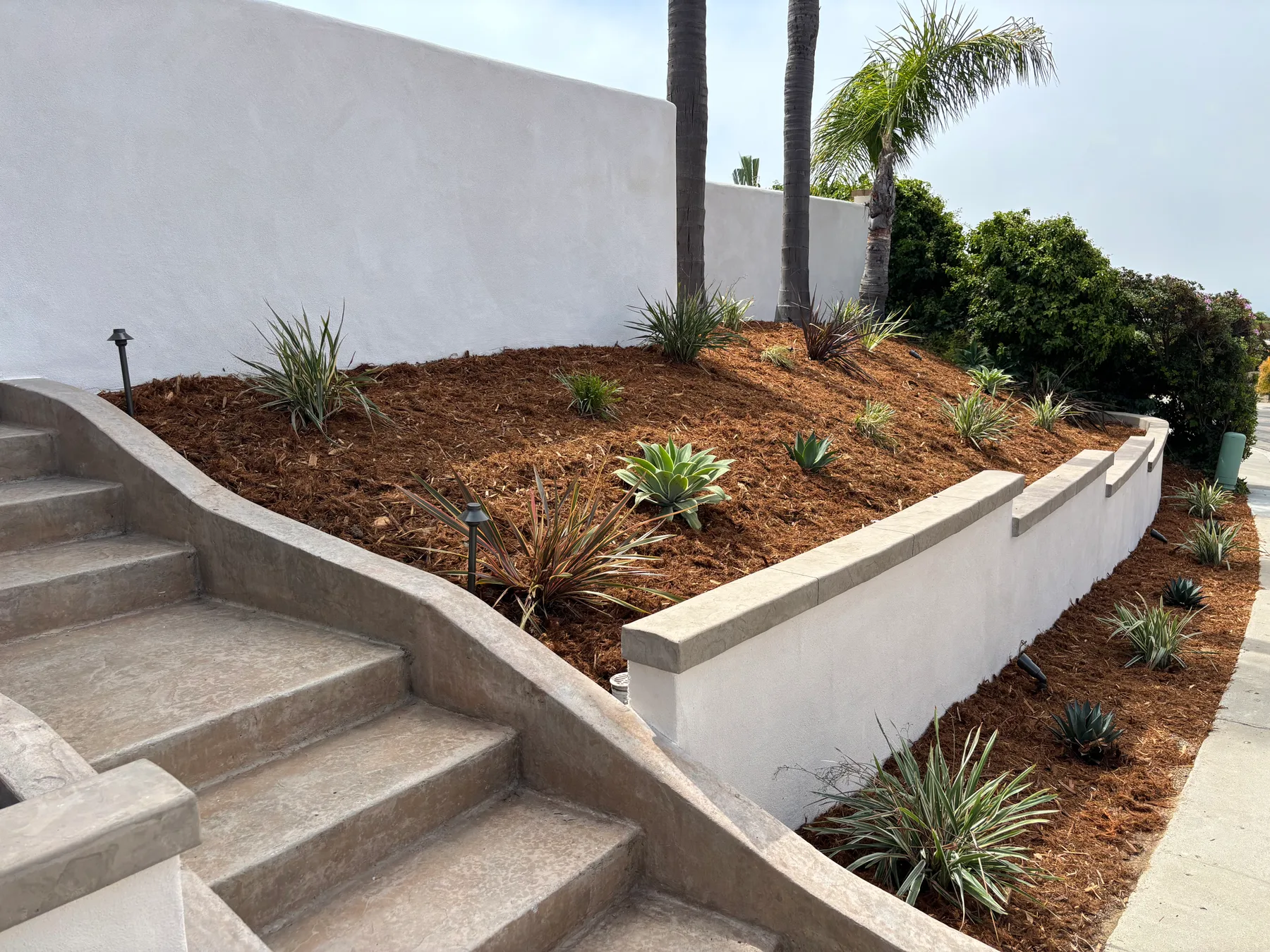 Professionally built retaining wall in a landscaped yard