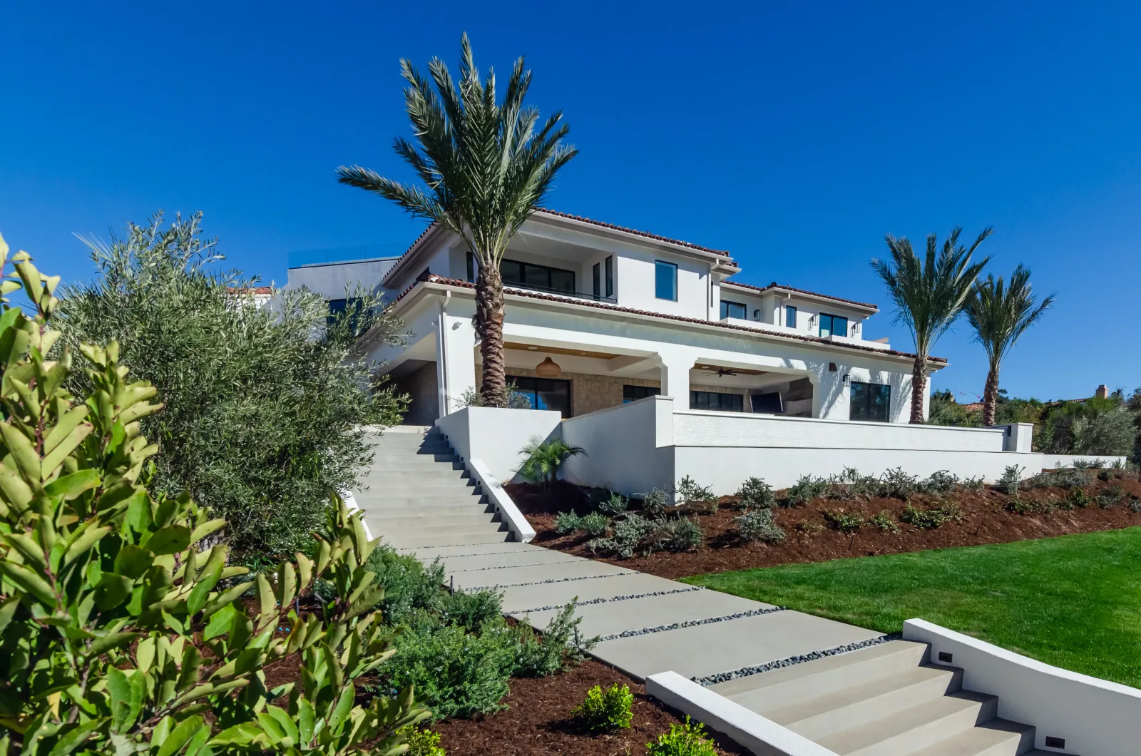 Custom patio cover providing shade over an outdoor living area in San Diego