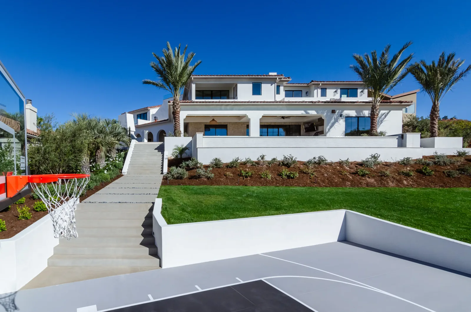 Custom outdoor fire pit and fireplace creating a focal point in a San Diego backyard