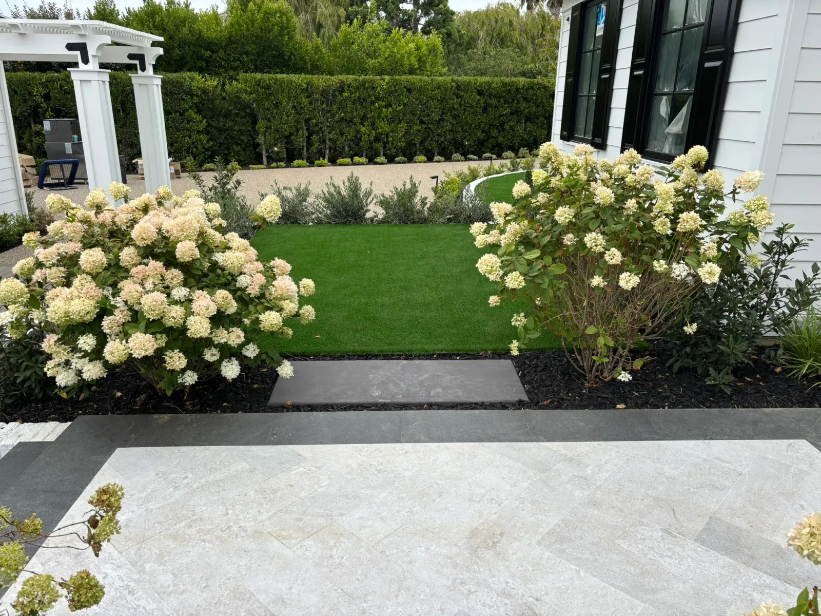 Retaining wall creating usable level space on a sloped property