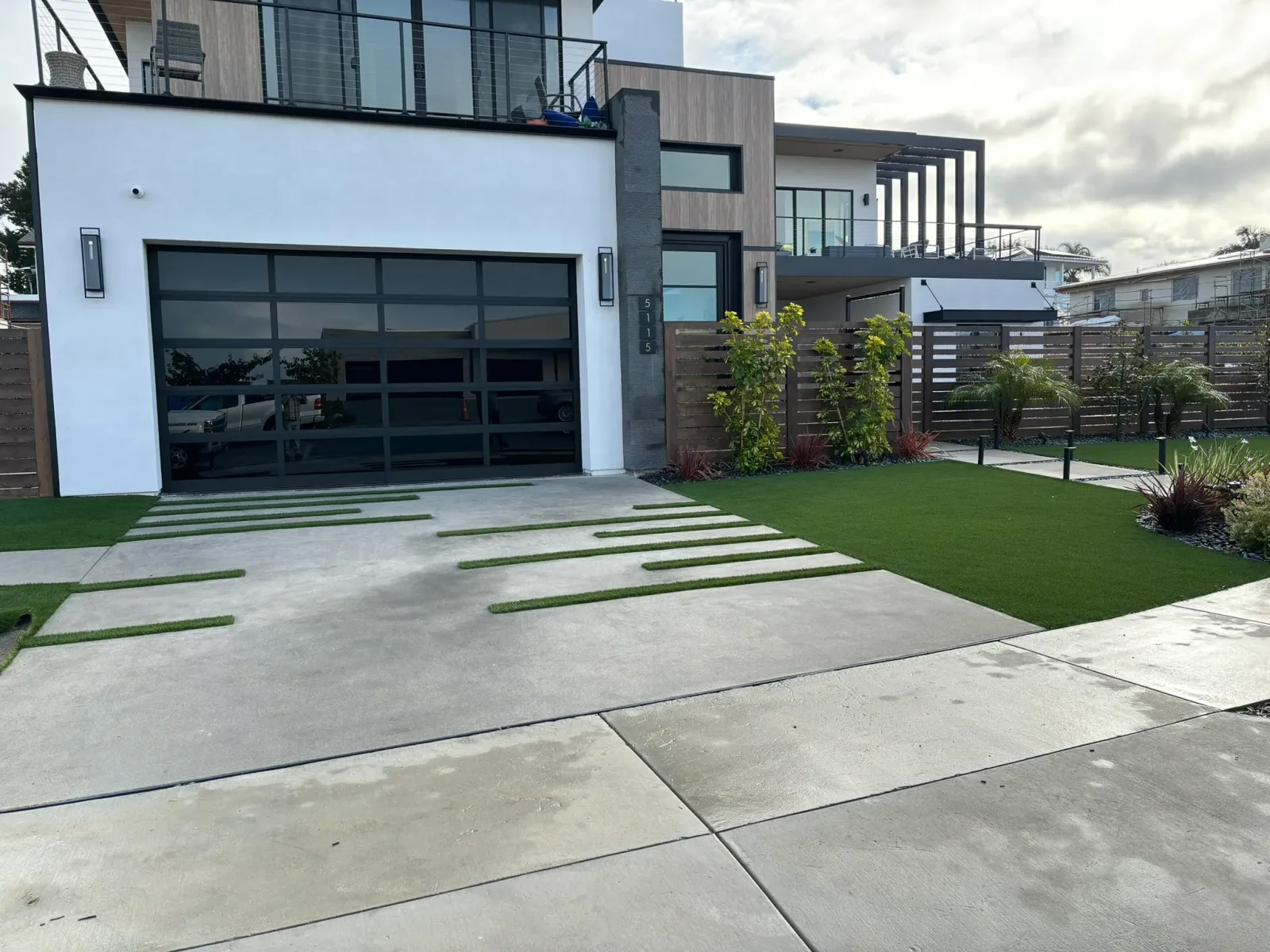 Cohesive backyard remodel with pavers, seat walls, and patio cover