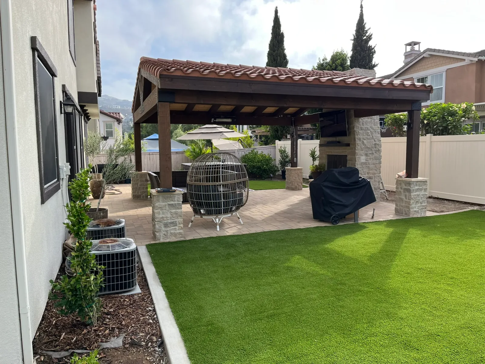 Outdoor fireplace as focal point of backyard gathering space